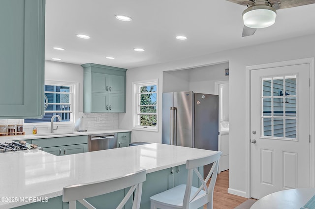 316 Rte 37, Seaside Heights, NJ 08751 - kitchen with a sink, tasteful backsplash, light wood-type flooring, a breakfast bar area, and stainless steel dishwasher