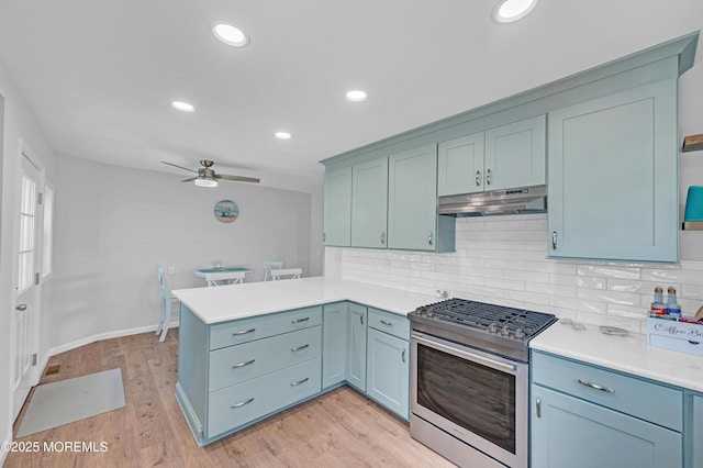 316 Rte 37, Seaside Heights, NJ 08751 - kitchen with under cabinet range hood, light countertops, stainless steel range with gas stovetop, a ceiling fan, and a peninsula