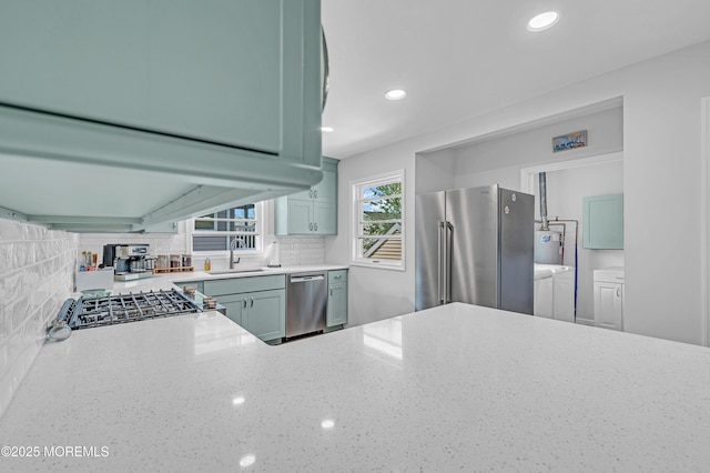 316 Rte 37, Seaside Heights, NJ 08751 - kitchen featuring light stone counters, independent washer and dryer, decorative backsplash, a sink, and stainless steel appliances