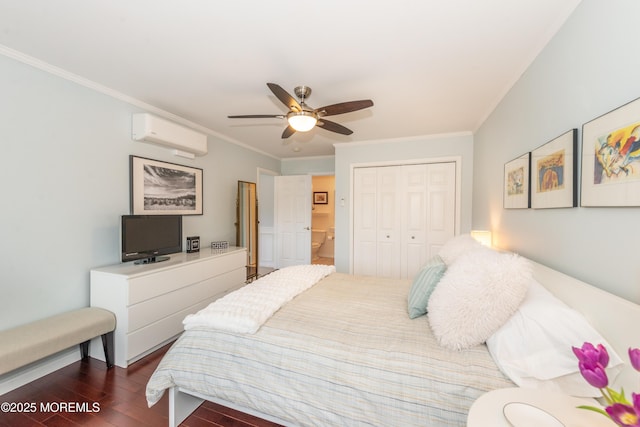 bedroom with crown molding, a closet, a wall mounted AC, a ceiling fan, and dark wood finished floors