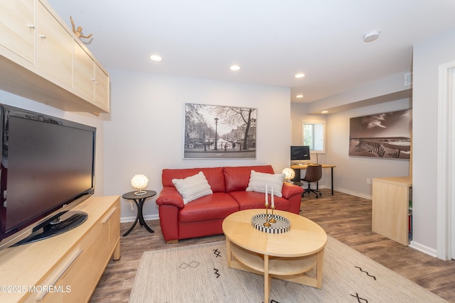 living area with baseboards, recessed lighting, and wood finished floors