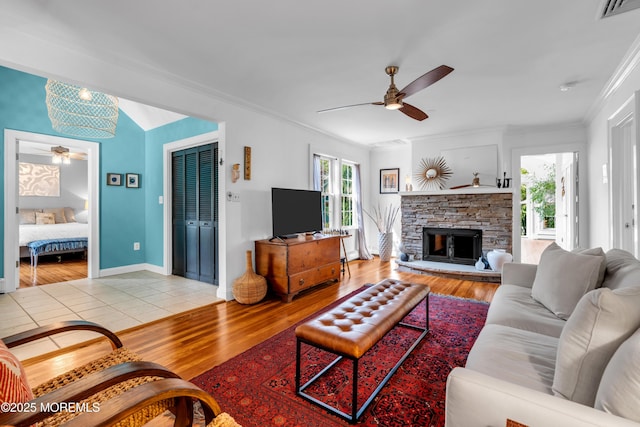 109 Capstan Ave, Beachwood, NJ 08722 - living room with ceiling fan, light wood-style floors, crown molding, a fireplace, and baseboards