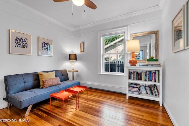 109 Capstan Ave, Beachwood, NJ 08722 - living area with wood-type flooring, crown molding, ceiling fan, baseboard heating, and baseboards