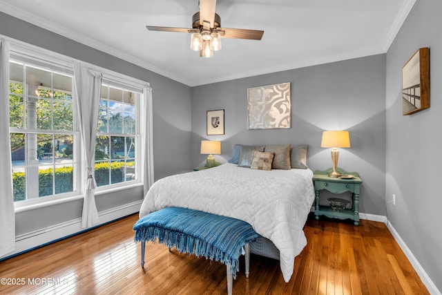 109 Capstan Ave, Beachwood, NJ 08722 - bedroom with hardwood / wood-style flooring, baseboards, crown molding, baseboard heating, and ceiling fan