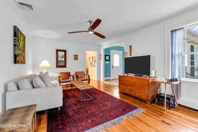 109 Capstan Ave, Beachwood, NJ 08722 - living room with crown molding, wood finished floors, a ceiling fan, and baseboard heating