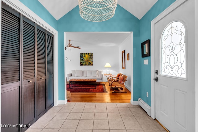 109 Capstan Ave, Beachwood, NJ 08722 - entrance foyer with vaulted ceiling, a baseboard radiator, light tile patterned floors, a ceiling fan, and baseboards