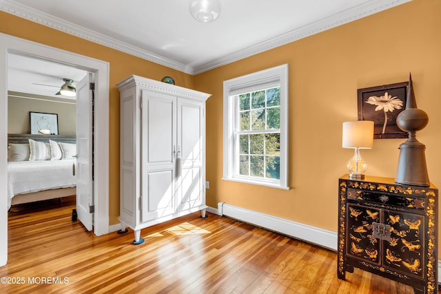 109 Capstan Ave, Beachwood, NJ 08722 - unfurnished bedroom featuring baseboard heating, baseboards, light wood finished floors, and ornamental molding