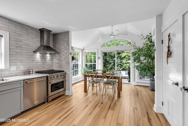 109 Capstan Ave, Beachwood, NJ 08722 - kitchen featuring wall chimney range hood, stainless steel appliances, gray cabinetry, ceiling fan, and light countertops