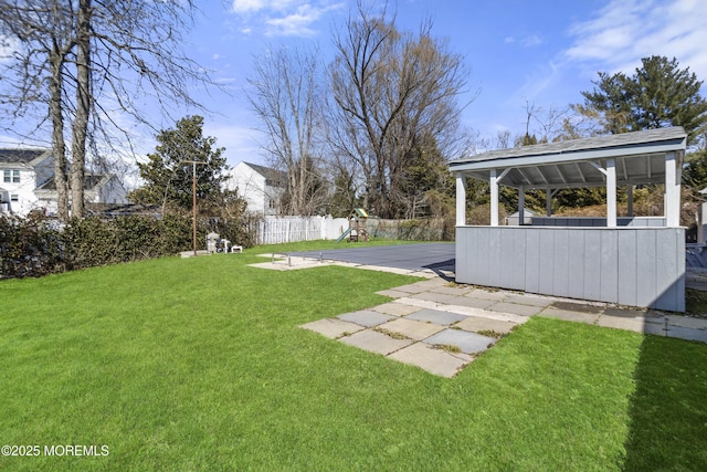 view of yard with fence, a patio, and a playground