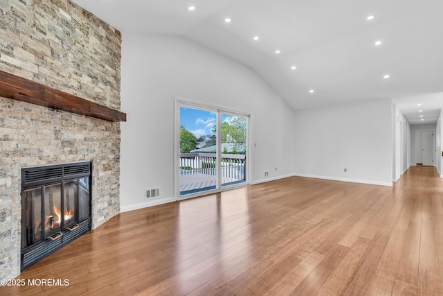 unfurnished living room with light wood finished floors, visible vents, baseboards, a stone fireplace, and recessed lighting