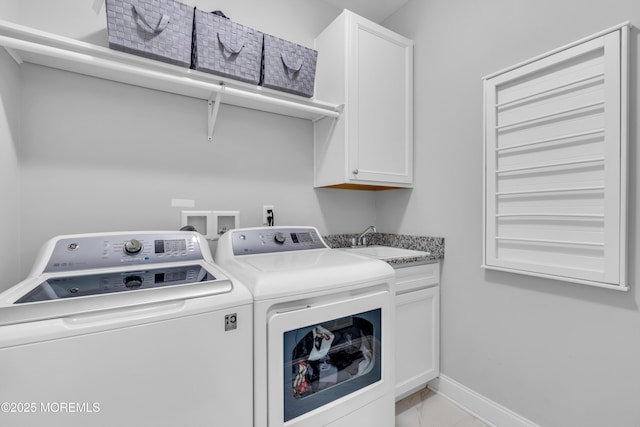 washroom with a sink, cabinet space, marble finish floor, separate washer and dryer, and baseboards