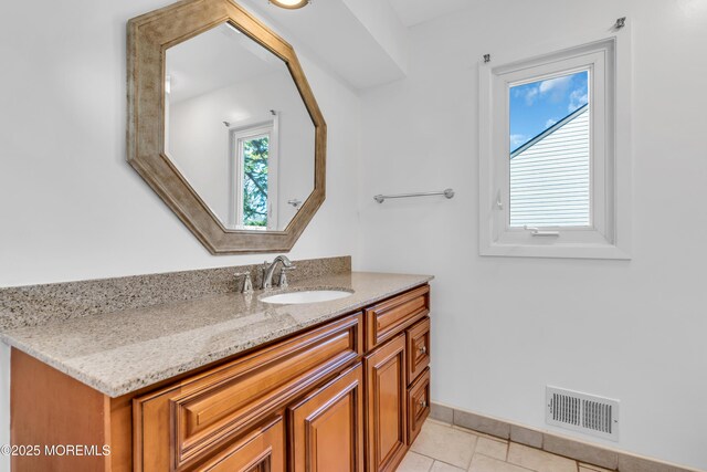 bathroom featuring visible vents, baseboards, vanity, and tile patterned flooring