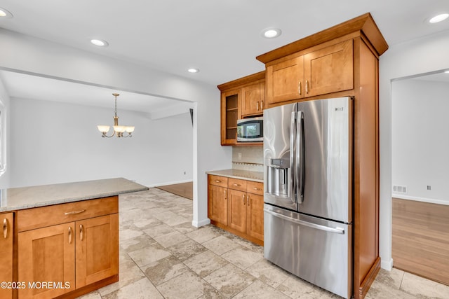 kitchen with brown cabinets, baseboards, recessed lighting, and appliances with stainless steel finishes