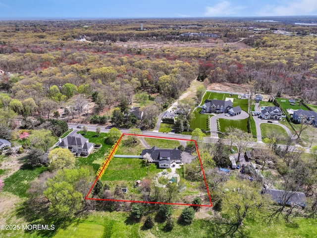 birds eye view of property featuring a residential view and a view of trees
