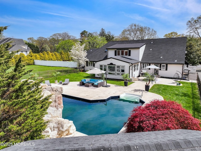 back of house featuring an outdoor living space, a yard, a fenced backyard, and a patio area