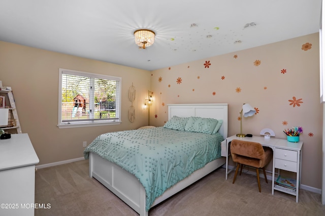 bedroom featuring light colored carpet and baseboards