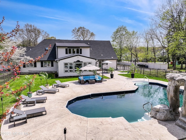 view of swimming pool featuring a patio, a yard, an outdoor hangout area, and a fenced backyard