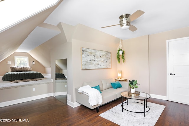 living area featuring baseboards, wood finished floors, a ceiling fan, and lofted ceiling