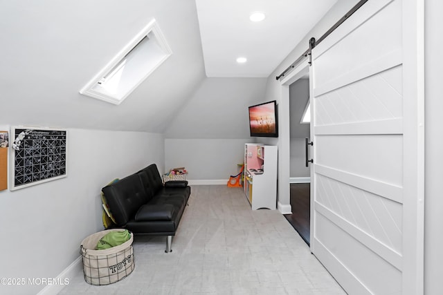 living area with recessed lighting, vaulted ceiling with skylight, a barn door, baseboards, and light colored carpet