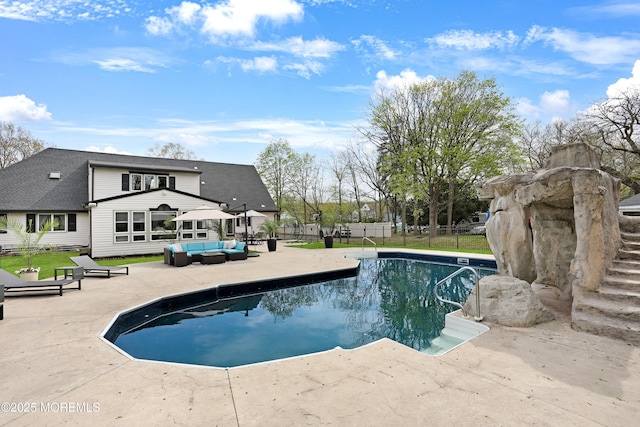 view of swimming pool featuring fence, a fenced in pool, a patio, outdoor lounge area, and a lawn