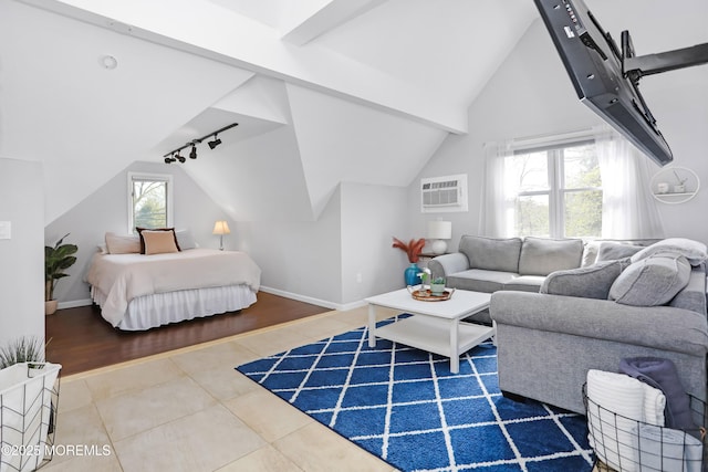 bedroom with rail lighting, lofted ceiling with beams, tile patterned floors, and baseboards