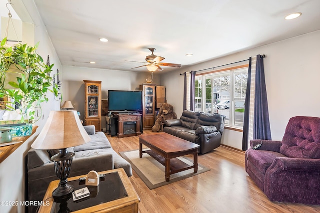 living area featuring recessed lighting, a ceiling fan, and light wood-style flooring