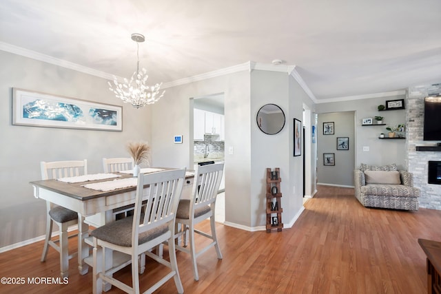204 Begonia Ct, Jackson, NJ 08527 - dining space featuring light wood-style flooring, baseboards, an inviting chandelier, and crown molding
