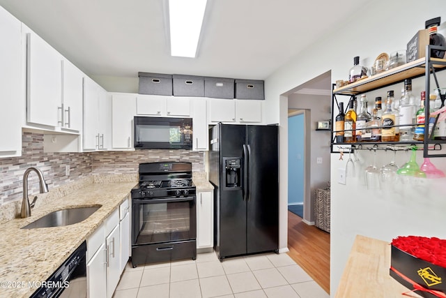 204 Begonia Ct, Jackson, NJ 08527 - kitchen featuring decorative backsplash, a sink, white cabinetry, and black appliances