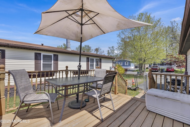 wooden terrace featuring outdoor dining area