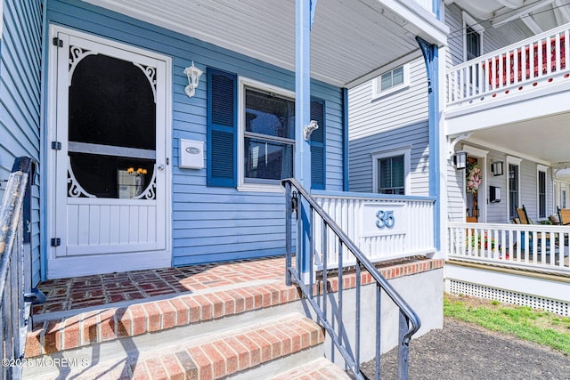 view of exterior entry with covered porch