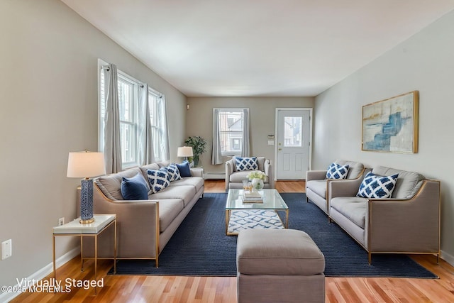 living room featuring wood finished floors and baseboards