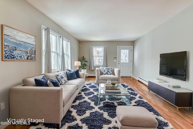 living area featuring light wood finished floors and a baseboard radiator