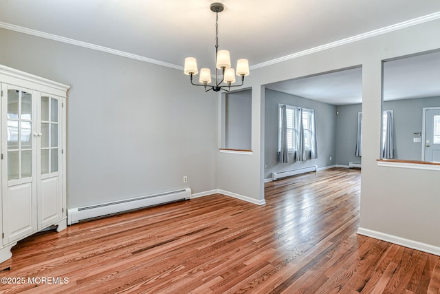 empty room featuring a baseboard radiator, a baseboard heating unit, a chandelier, wood finished floors, and crown molding