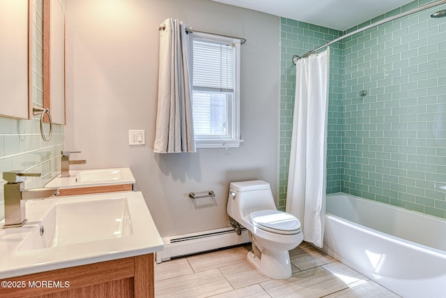 bathroom featuring a baseboard heating unit, toilet, double vanity, shower / tub combo, and backsplash