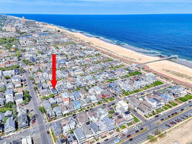 aerial view of property and surrounding area with expansive beach