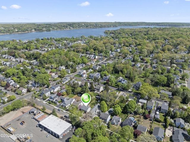 drone / aerial view featuring a water view and a residential view