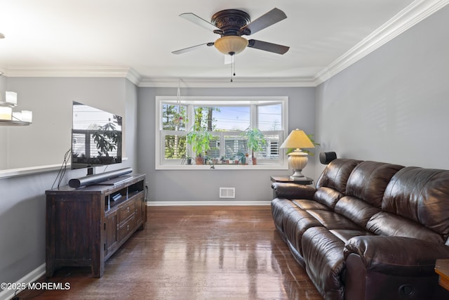 living area with a ceiling fan, visible vents, ornamental molding, and wood finished floors