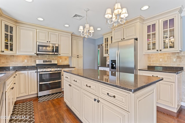 kitchen featuring stainless steel appliances and cream cabinetry