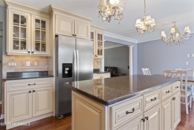 kitchen featuring decorative backsplash, dark wood-style flooring, stainless steel fridge with ice dispenser, a chandelier, and cream cabinetry