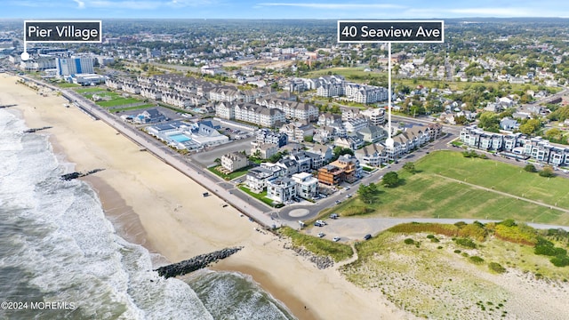 birds eye view of property featuring a view of the beach and a water view
