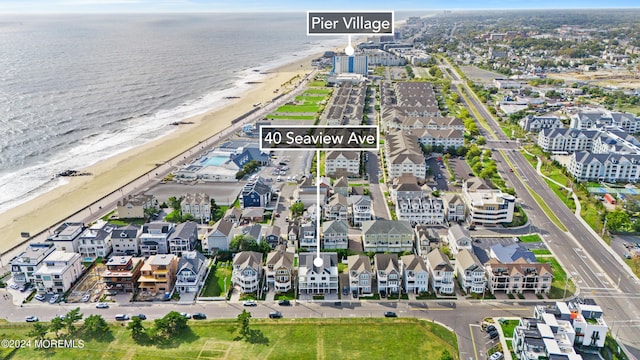 aerial view featuring a view of the beach and a water view