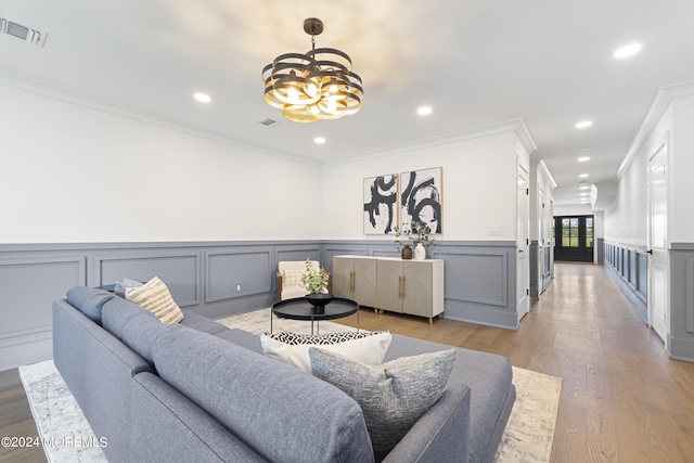 living room featuring ornamental molding, a notable chandelier, visible vents, and recessed lighting