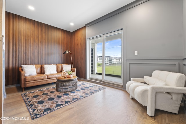 living area featuring wooden walls, wood finished floors, and recessed lighting
