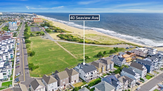 birds eye view of property featuring a view of the beach and a water view