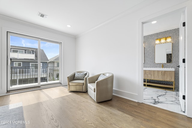 sitting room with recessed lighting, visible vents, crown molding, and baseboards