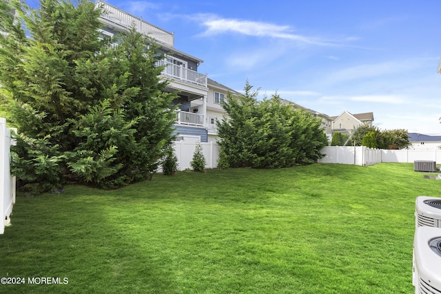 view of yard featuring cooling unit and fence
