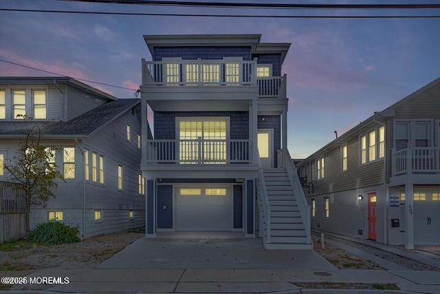 303 Webster Ave, Seaside Heights, NJ 08751 - raised beach house featuring a balcony, stairway, an attached garage, and concrete driveway