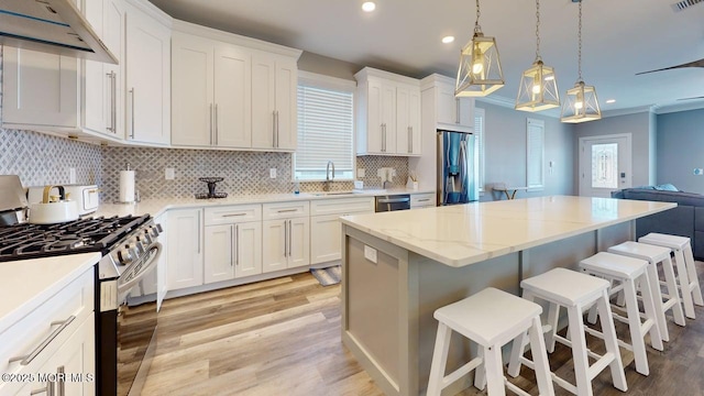 303 Webster Ave, Seaside Heights, NJ 08751 - kitchen featuring stainless steel appliances, under cabinet range hood, light wood finished floors, a kitchen island, and recessed lighting