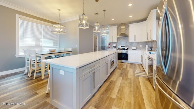 303 Webster Ave, Seaside Heights, NJ 08751 - kitchen with stainless steel appliances, wall chimney exhaust hood, a kitchen island, ornamental molding, and tasteful backsplash