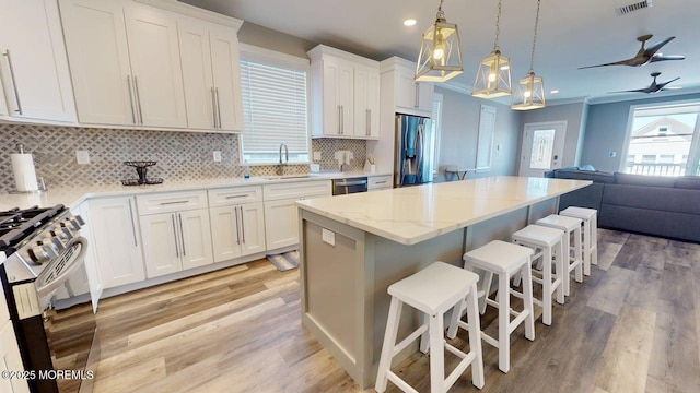 303 Webster Ave, Seaside Heights, NJ 08751 - kitchen with appliances with stainless steel finishes, a sink, open floor plan, light wood-style flooring, and recessed lighting